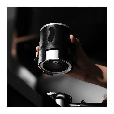 Espresso Gang Verified Shaker Funnel With Built In Dosing Cup For 58mm Portafilter shown in hand, highlighting stainless steel and black finish.