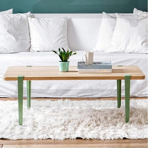 Adjustable Metal Table Legs With Signature F Shape Profile And Self Leveling Base Heavy Duty Powder Coated Steel Construction No Drill Assembly under wooden tabletop with plant.