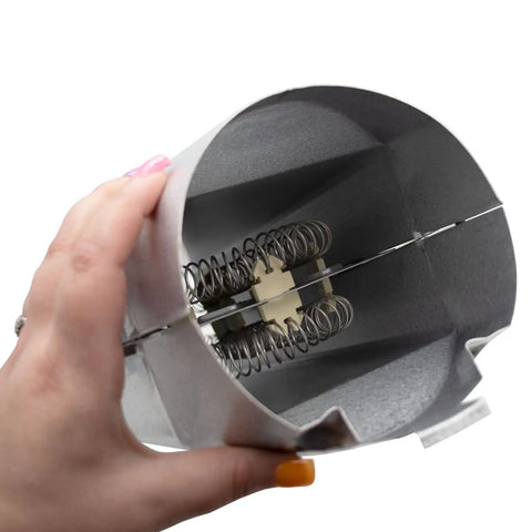 Hand holding dryer heating element canister replacement with heater casing and two thermostats, DC47-00019A element visible inside.