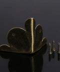 Solid Antique Bronze Corner Protectors, 12 Piece Heavy Duty Furniture Edge Guards with screws on black surface.
