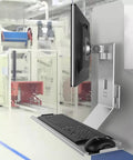 Industrial Monitor Mount And Keyboard Tray Featuring Slick Multi Angle Swivel Arm With Foldable Design For Zero Sweat Setup And Ultimate Clean Desk Flex In Your Premium Work Space Setup with monitor and keyboard in a factory setting.