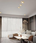 Kick Up Your Space With These Solid Brass Round Dimmable LED Recessed Downlights Featuring Anti Glare Tech And A Smooth 7W Glow in a modern living room.