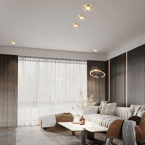 Kick Up Your Space With These Solid Brass Round Dimmable LED Recessed Downlights Featuring Anti Glare Tech And A Smooth 7W Glow in a modern living room.