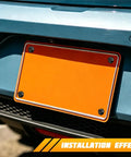 Installation view of Hella Tough Slotted Stainless Steel License Plate Screws in black on a vehicle's rear license plate.