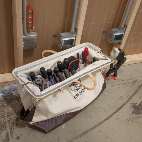 Open 24 Inch Deluxe Canvas Tool Tote with 17 interior pockets, detachable shoulder strap, and vinyl bottom holding tools.