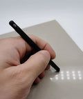 Hand holding Seven Piece Hardness Test Kit For Rocks And Gems With Portable Scratch Pen Set 3 To 9 Mohs Includes Durable Storage Box For Easy Carry Grab And Go Mineral ID For Industrial Use And Gem Jade Testing. pen