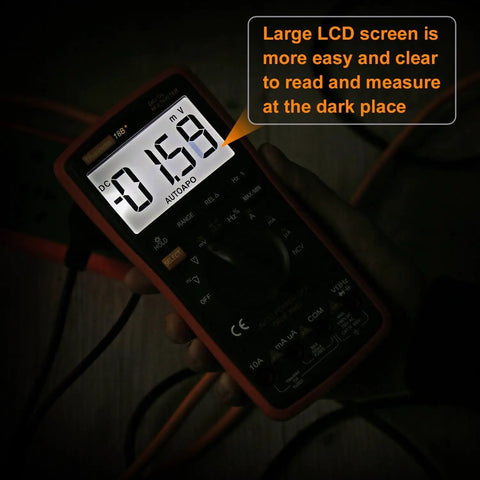 Ranging Digital Multimeter TRMS 6000 with large LCD screen displaying measurement, held in hand in a dimly lit area