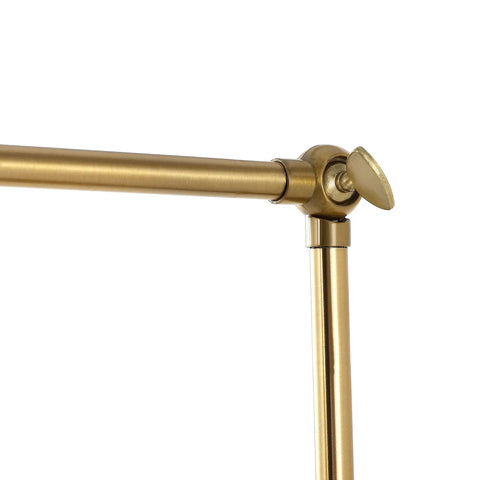 Close-up of swing arm joint in warm brass gold finish on wall lamp