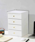 Solid Wood Desktop File Cabinet With Four Drawers Home Office Organizer in white on desk with books and laptop.