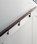 Heavy Duty Zinc Alloy Stair Brackets Matte Black Handrail Support 5 Pack installed on a wooden railing in a modern staircase.