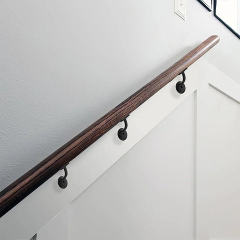Heavy Duty Zinc Alloy Stair Brackets Matte Black Handrail Support 5 Pack installed on a wooden railing in a modern staircase.