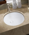 Isabella Plus 16 Inch Oval Undermount Basin With Overflow And Rear Center Drain White ceramic sink installed in countertop