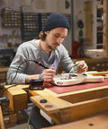 Top Tier Cordless Pen Engraver And Digital Soldering Iron Kit With Sweet 20V Battery being used for electronics repair on a guitar.