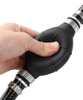 Hand gripping primer bulb on Universal 3/8 Inch Boat Fuel Line Assembly Kit with steel hose clamps and dual check valves