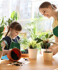 Child and adult gardening indoors with plants from Kids Metal Garden Tool Set For Little Green Thumbs With Real Shovel Rake Fork Trowel Sun Hat Apron Gloves Tote Bag Sprayer and Bucket Educational Outdoor Garden Gift