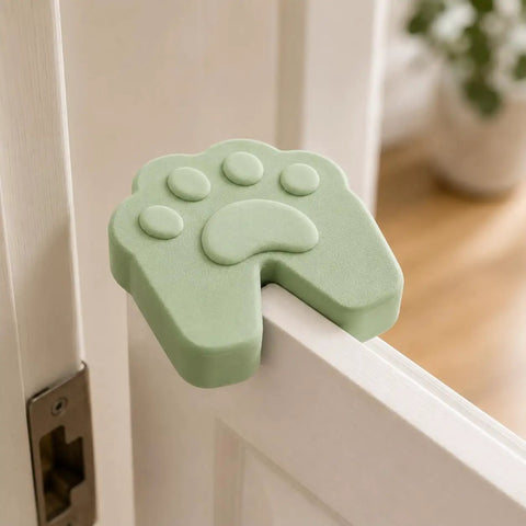 Six Pack Soft Foam Paw Shaped Door Stoppers For Finger Pinch Protection In Pastel Colors Sage Cream Peach Lavender Butter Yellow White Ideal For Homes With Kids And Pets; sage paw stopper on door