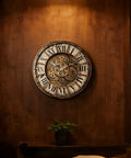 18 Inch Moving Gears Wall Clock Oversized Industrial Steampunk Design With Antique Oil Rubbed Bronze Finish on wooden wall.