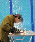 Worker welding with sparks flying, background uses Aqua Shield Surface Protector 10 Mil 36 Inch By 100 Foot Heavy Duty Protective Film.