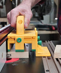 GRR RIPPER GR 100 3D Adjustable Table Saw Pushblock in use on table saw, bright yellow, guiding wood for precise cut.