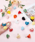 Heart Shaped Porcelain Cabinet Knobs Set 24 Pieces In 12 Colorways Ceramic Kitchen Dresser Knobs arranged on table with hand holding