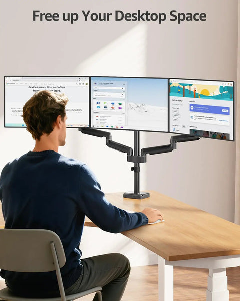 Triple Monitor Desk Mount For Up To 27 Inch Screens, Heavy Duty Arm System With Each Arm Holding 4.4 To 19.8 Lbs, Vesa 75x75 And 100x100 Compatible, Fully Adjustable Triple Monitor Stand For Your Desktop Rig, Black displayed in office setup with three monitors, mounted on desk.