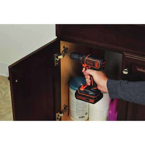 Person using 20V Max Cordless Drill Driver Kit With Battery And Charger Includes Double Ended Bit Lightweight 3.15 Lbs 11 Position Clutch For Precision 0 To 650 RPM Delivers 115 Lbs Of Torque For Wood Metal Plastic Projects Your Go To Power Tool on a cabinet hinge