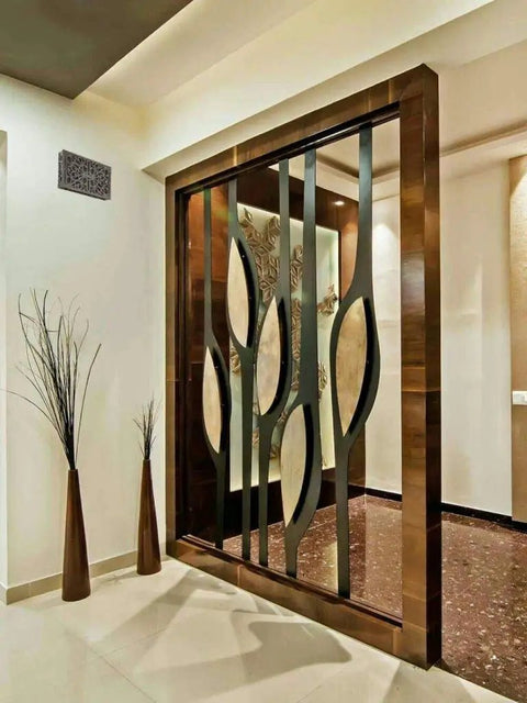 Modern interior design with metal and glass partition, bronze accents, and decorative wall details.