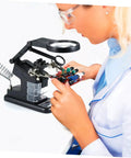 Person using Usb Soldering Station With Led Magnifying Lamp And Adjustable Third Hand Clamp For Electronics Repair on circuit board.
