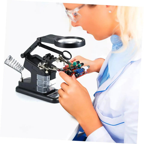 Person using Usb Soldering Station With Led Magnifying Lamp And Adjustable Third Hand Clamp For Electronics Repair on circuit board.