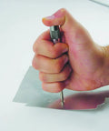 Heavy Duty Automatic Center Punch With Adjustable Stroke And Slick Stainless Steel Body in use, marking metal for drilling.