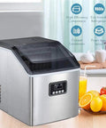 Portable Automatic Countertop Ice Cube Maker Cranks Out Forty Eight Pounds Daily With Quick Ten Minute Rounds Self Clean Design Saves Effort While You Fuel Yard Gatherings Or Super Bowl Watch Parties Silver Trim beside fresh fruit and drinks.
