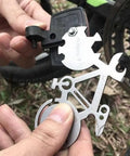 Hands holding All In One Bicycle 10 In 1 Multitool Card For Everyday Carry And Keychain Access With Wrenches in use