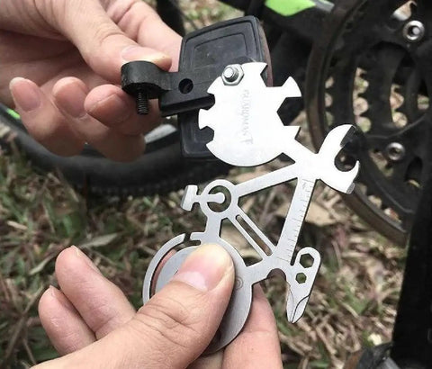 Hands holding All In One Bicycle 10 In 1 Multitool Card For Everyday Carry And Keychain Access With Wrenches in use