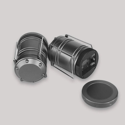 Two gray Lichamp LED camping lanterns with battery compartments and metal handles.