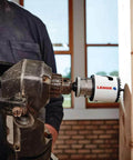 Lenox 2-3/4 in bi-metal speed-slot hole saw on a drill cutting wood