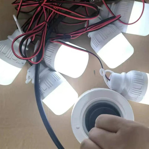 Hand holding 40W Brushless DC Motor With Dual Purpose Micro Gen Reversible Power Output 310V Ball Bearing System beside LED bulbs