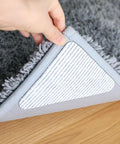 Person lifting rug showing Anti Slip Rug Grippers For Vinyl Floors And Tile That Keep Area Rugs In Place And Stay Put On Hardwood Floors