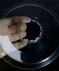 Hand holding 2 Pack Freewheel Spoke Protectors 138mm Diameter for Mountain and Road Bikes, flywheel guard visible