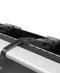 Close-up of Premium Roof Rack Wind Fairing clip mount securing to aero blade bars in classic black, showing tool-free installation.