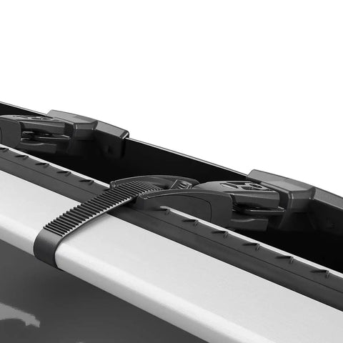 Close-up of Premium Roof Rack Wind Fairing clip mount securing to aero blade bars in classic black, showing tool-free installation.
