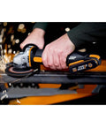 No Hassle Heavy Duty Cordless Angle Grinder With 20 Volt Lithium Ion Battery in use, cutting steel with sparks flying.