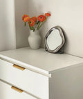 Gold Adhesive Edge Finger Pulls For Cabinets 5 Pack With Screws And Tape installed on white drawer in living room setting