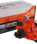 Industrial Water Pressure Pump With Wall Plug 115V AC 3.3 GPM 45 PSI Self Priming Up To 6 Feet Built In Adjustable Pressure UL 778 CSA Certified Easy Plug In Power Connection placed beside its packaging box.