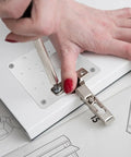 Stainless Steel Hinge Repair Kit For Cabinets And Doors With Screws being installed on a cabinet door