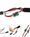 Front view of a 5–6V steering gear delay module with red, black, white wires and a small green PCB.