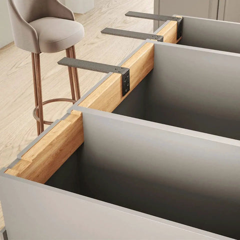 Beefy Heavy Duty Countertop Support Bracket Set Two Pack For Granite Quartz Wood Concrete And Laminate Countertops L Shaped Iron Shelf Brackets Twenty By Eight By Two And A Half Inches Hidden Forward Mount Ultra Strong Kitchen Shelf Supports installed under a wooden countertop in a modern kitchen.