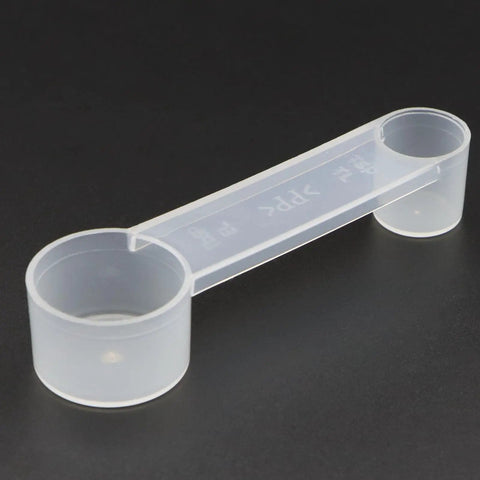 3-Piece Bread Machine Accessories Kit With 300ml Measuring Cup, clear dual-ended plastic measuring spoon on a black background
