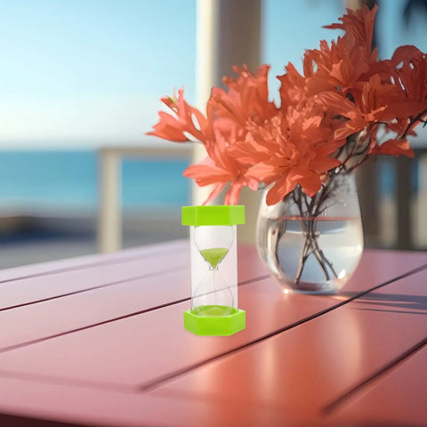 2 Minute Mini Hexagon Sand Timer In Grass Green for quick visual time reminders, placed on a pink outdoor table with flowers