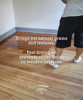 Person applying Fast Drying Boiled Linseed Oil For Wood Care, No Fuss Wood Treatment on a wooden floor with visible grain texture.