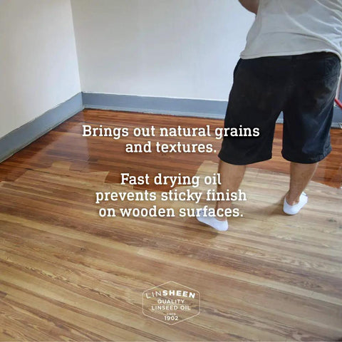 Person applying Fast Drying Boiled Linseed Oil For Wood Care, No Fuss Wood Treatment on a wooden floor with visible grain texture.